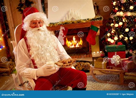 Santa Claus Resting In Warm Room And Eating Traditional Christmas