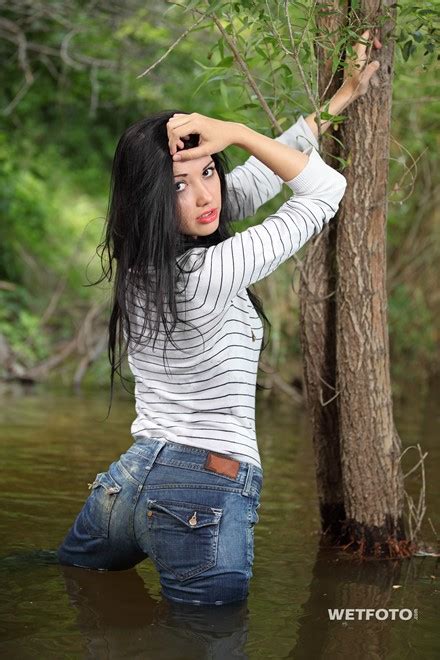 wetlook by beautiful girl in striped sweater tight jeans and high heels by the river