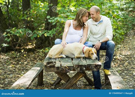 Happy Couple With Their Dog Stock Image Image Of Holding Recreation