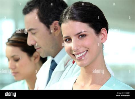 Smiling Hospital Nurse Standing With Colleagues Stock Photo Alamy