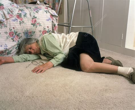 elderly woman lying on floor after a fall stock image m340 0162 science photo library