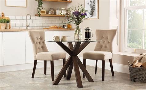 This charming dining table is the perfect addition to your dining room or kitchen. Hatton Round Dark Wood and Glass Dining Table with 2 ...