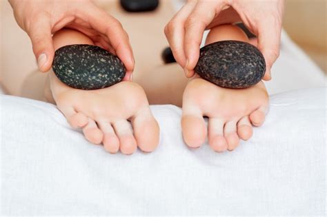Premium Photo Feet Massage By Hot Stones