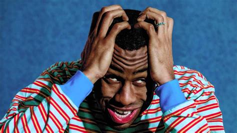 Tyler The Creator Is Having Hands On Head In A Blue Background Hd Music
