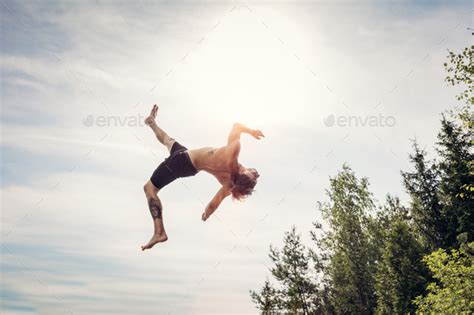 Young Man Doing A Backflip In The Air Stock Photo By Photocreo Photodune