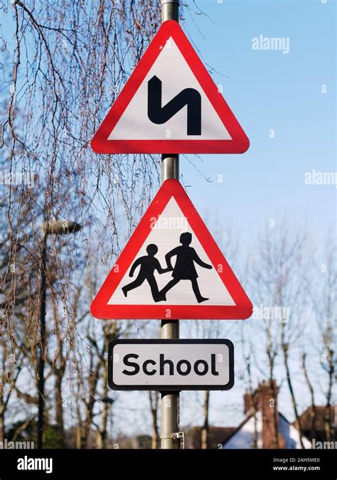 Double Bend First To Left Sign And School Children Crossing Sign Uk