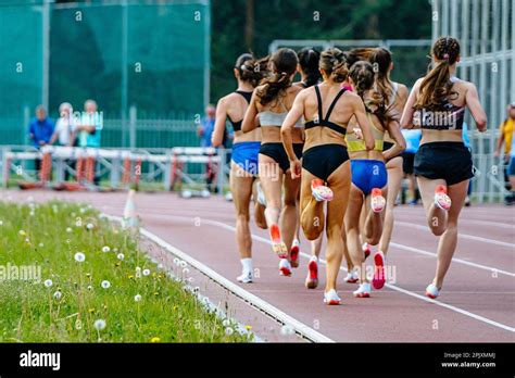 back group female runners running middle distance race summer athletics championships at
