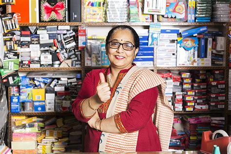 1 Shopkeeper Female Showing Thumbs Up Success In Stationary Shop