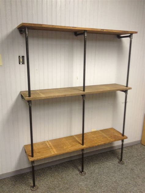 When installing a shelf unit in your space, you can attach it to a wall. Pipe shelf | Black iron pipe creations | Pinterest