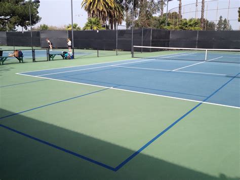 Picture of a tennis court. Can Pickleball Be Played On A Tennis Court?