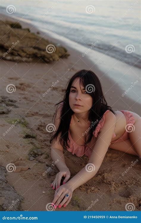 Beautiful Brunette Woman On The Beach Near Sea At Summer Sunset Portrait With Soft Even