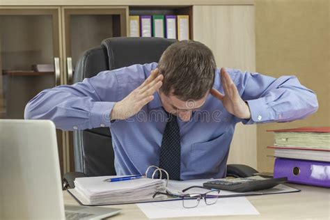 Boss Businessman At His Desk In The Office With A Pile Of Folders