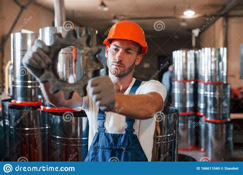 Construction Part Man In Uniform Works On The Production Stock Photo