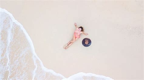 Premium Photo Aerial Top View Young Woman In A Bikini Lying On The