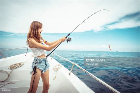 Asian Girls Fishing On A Boat High Res Stock Photo Getty Images