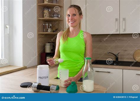 Caucasian Woman In Gym Suit Mixing Protein Shake With Milk Stock Image