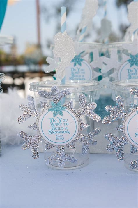 Snowflakes Are Sitting In Plastic Cups On A Table