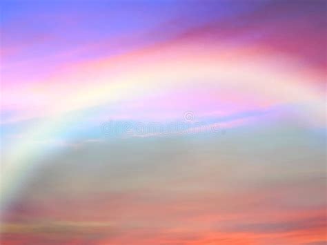 Sunset Pink And Blue Sky With Rainbow At Sky Fluffy Clouds Skyline