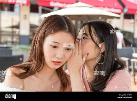 Two Girls Are Whispering Stock Photo Alamy