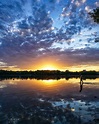 Wading into the water at sunset. : r/MostBeautiful