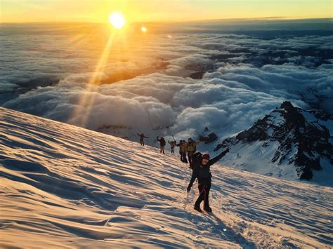 Climbers High On Rainier At Sunrise After Climbing The Ingraham Direct