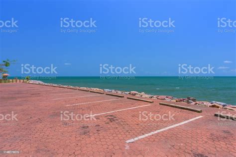 Empty Parking Lot Against Sea And Beautiful Blue Sky Stock Photo