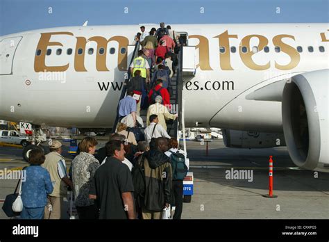 Passengers Boarding An Aircraft Of Emirates Airlines Stock Photo Alamy