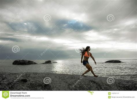 Woman Landing On A Rock At Sunset On Bakovern Beach Cape Town Stock Image Image Of Landing