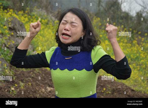 A Chinese Woman Cries With Her Fists In The Air During An Unusual