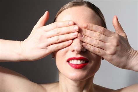 Close Up Of Young Attractive Woman Covers Her Eyes With Hands And