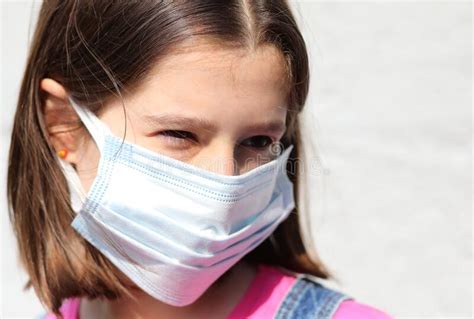 Intense Eyes Look Of The Girl With Surgical Mask During The Lock Stock