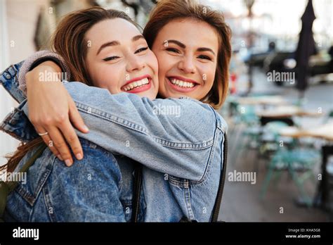 Close Up Photo Of Two Attractive Happy Woman Friends Hugging Each Other