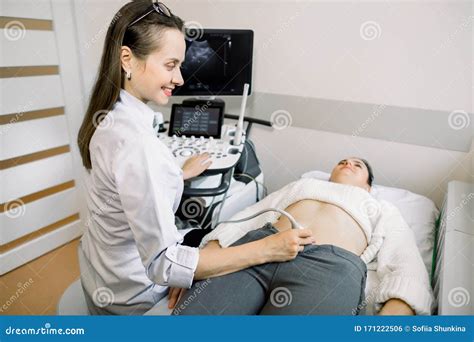 Female Doctor Performs Ultrasound Examination Of Pelvic Organs Of Her Female Patient For