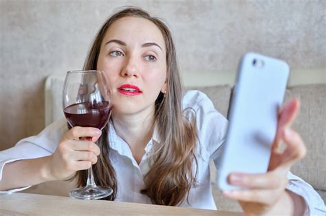 premium photo drunk girl with a glass of wine takes a selfie photo