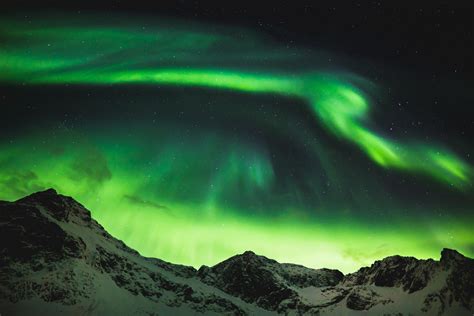 Explosive Aurora over the jagged mountains of Norway. [OC] [4240x2832