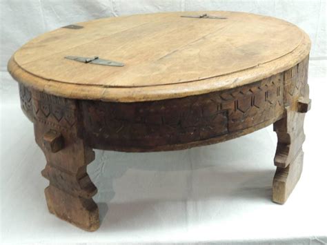 This beautifully ornate coffee table has sides 'segmented' into a series of rectangular shapes which are slightly curved. Moroccan Carved Round Coffee Table For Sale at 1stdibs