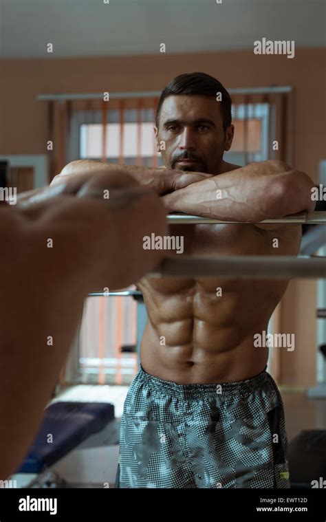 Muscular Man Flexing Abdominal Muscles Abs In A Health Club Stock Photo