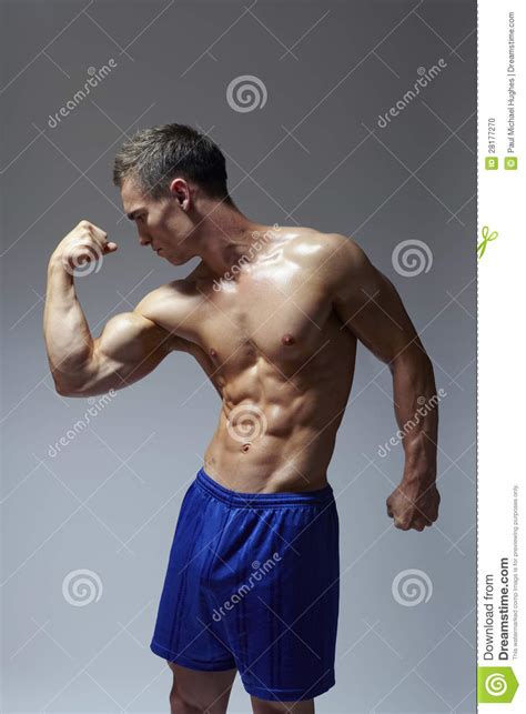 Muscular Young Man Flexing Arm Muscles Stock Photo Image 28177270