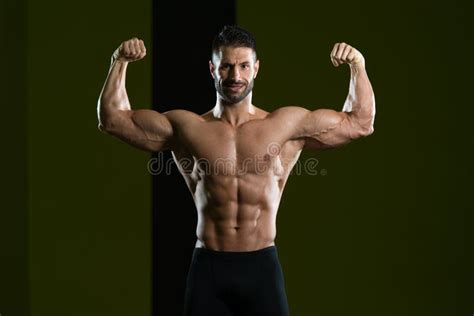 Muscular Man Flexing Muscles In Gym Stock Photo Image Of Clothing