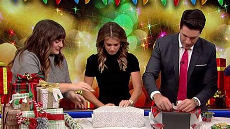 Rob Schmitt And Jillian Mele Compete In A Holiday Wrap Battle On Air