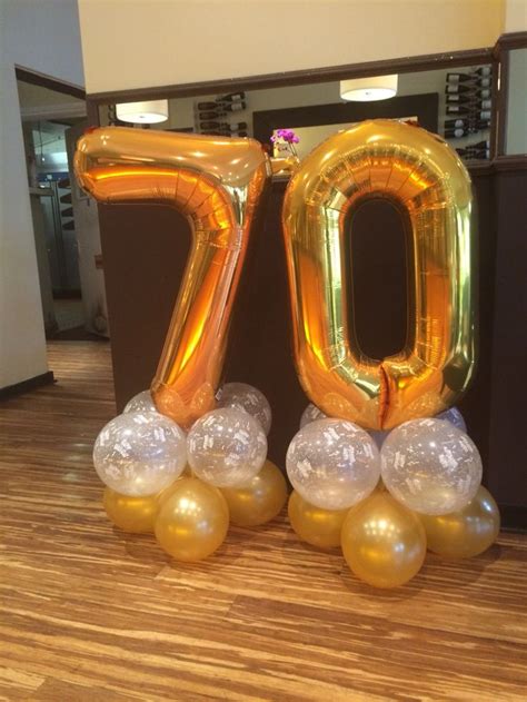 The guest of honor has earned the respect and admiration of family and friends, and no doubt has memories and wisdom to share. 70th Birthday balloons in gold and clear 'happy birthday ...