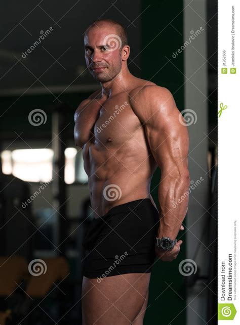 Young Bodybuilder Flexing Muscles Stock Photo Image Of Brown Male