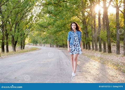 Girl Walking On A Countryside Road Royalty Free Stock Image
