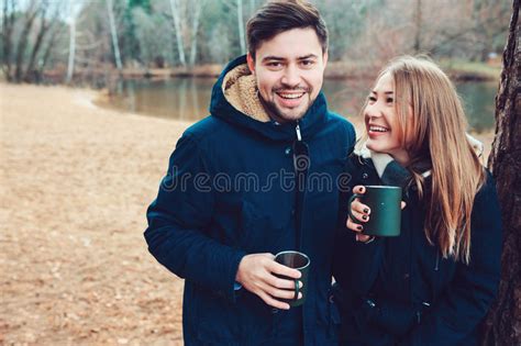 Lifestyle Capture Of Couple Drinking Hot Tea Outdoor On Cozy Warm Walk