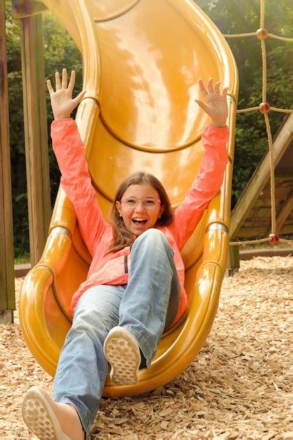 Premium Photo Teenage Girl Is Having Fun In The Playground Holiday Concept Photo