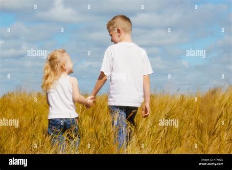 Two Young Children Holding Hands Stock Photo Alamy