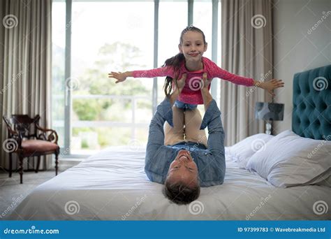 Smiling Father Lifting Her Daughter On The Bed Stock Image Image Of Life Innocence 97399783
