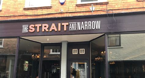 Most commonly it is a channel of water that lies between two land masses. Strait and Narrow Pub and Bar in Lincoln