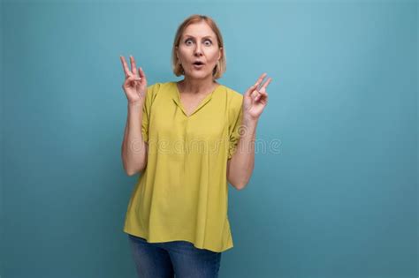 Thoughtful Blonde Mature Woman In Yellow T Shirt With Emotions Of