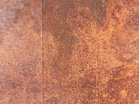 Rusted Metal Wall With Discoloration Featuring Shades Of Brown Free